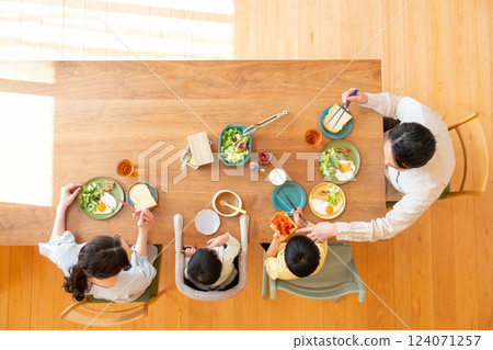 Young family eating at the table Young family eating at the table 124071257