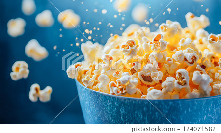 Popcorn jumping out of a bowl, creating an inviting snack atmosphere in a cozy kitchen 124071582
