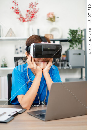 A healthcare worker in scrubs explores virtual reality technology in a contemporary office setting, showcasing innovation in medical training. A healthcare worker in scrubs explores virtual reality technology in a contemporary office setting, showcasing innovation in medical training. 124071710