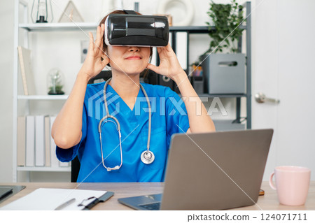 Medical professional in scrubs using VR headset for training, showcasing innovation in healthcare technology. Medical professional in scrubs using VR headset for training, showcasing innovation in healthcare technology. 124071711