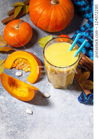 Healthy Autumn pumpkin smoothie with cinnamon in glass on a stone countertop. Copy space. 124072280