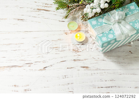Christmas concept. Christmas presents gift blue box and festive decor on a wooden table. Copy space. 124072292
