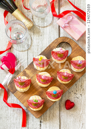 Valentines day or birthday romantic snacks. Canapes with bread, cheese, salami and olives. Flat top view. Valentines day or birthday romantic snacks. Canapes with bread, cheese, salami and olives. Flat top view. 124072689