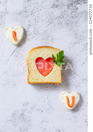 Breakfast for valentine's day or mother's day, toast with salmon and curd cheese with the inscription that I love you. Top view flat lay. Breakfast for valentine's day or mother's day, toast with salmon and curd cheese with the inscription that I love you. Top view flat lay. 124072710