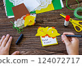 Instruction step 15. Child gift postcard happy easter chickens toy on a wooden table. Handmade. Project of children's creativity, handicrafts, crafts for kids. 124072717