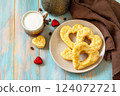 Breakfast for valentine's day or mother's day concept. Curd cheese pastries and a cup of cappuccino coffee on a rustic table. 124072721