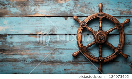 A detailed shot of a ship's helm on a light wooden background, providing room for text. picture 124073495