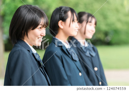 Friendly female students walking through the school building with smiles on their faces (going to school, going home, commuting to school) 124074559