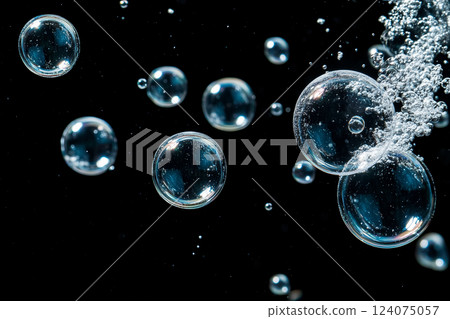 Large Underwater Bubbles Floating Against a Dark Background 124075057