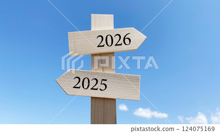 Signpost and blue sky_2 directions_middle_2026 and 2025 with text Signpost and blue sky_2 directions_middle_2026 and 2025 with text 124075169