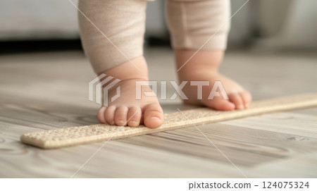 Toddler Stepping on Textured Board to Improve Foot Alignment 124075324