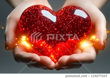 Red Heart Sparkling in Hands on Light Background 124075507