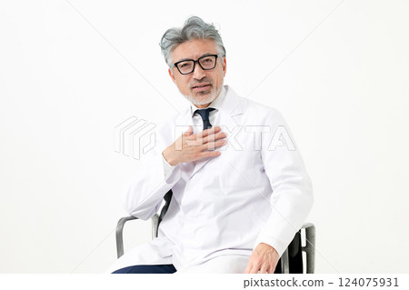 A man in a white coat sitting on a chair A man in a white coat sitting on a chair 124075931
