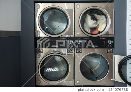 Washing machines in laundromat 124076788