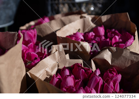 Vibrant Pink Petals Overflowing from Brown Paper Bags: A Colorful Display of Nature's Beauty in Untouched Blooms Capturing the Essence of Fresh Flowers and Springtime Vibes 124077334