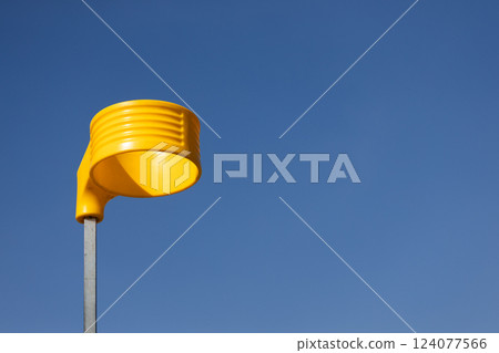 A Bright Yellow Street Light Fixture Against a Clear Blue Sky, Showcasing Modern Urban Design and Architectural Creativity in Public Spaces A Bright Yellow Street Light Fixture Against a Clear Blue Sky, Showcasing Modern Urban Design and Architectural Creativity in Public Spaces 124077566
