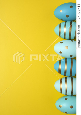 Empty yellow background with Easter eggs Empty yellow background with Easter eggs 124077611