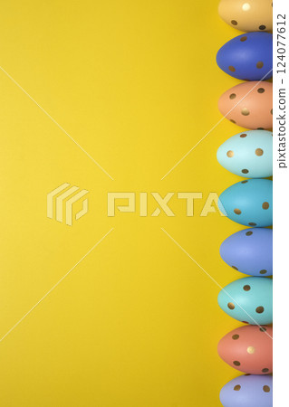 Empty yellow background with Easter eggs Empty yellow background with Easter eggs 124077612
