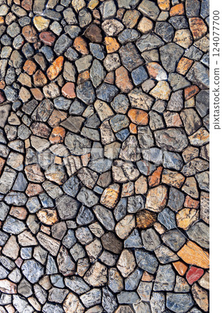 Natural stone background featuring rough irregularly shaped rocks in earthy tones, visible cracks 124077700