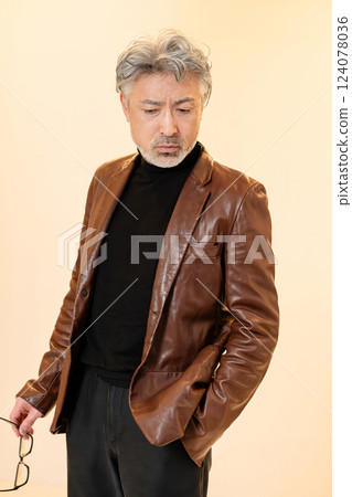 Middle-aged man wearing a leather jacket Middle-aged man wearing a leather jacket 124078036