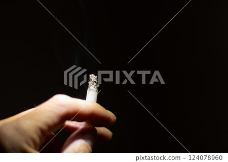 Male hand smoking cigarette Male hand smoking cigarette 124078960