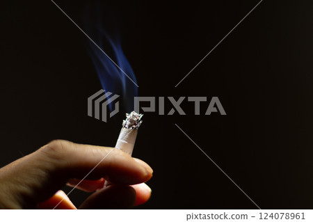 Male hand smoking cigarette 124078961