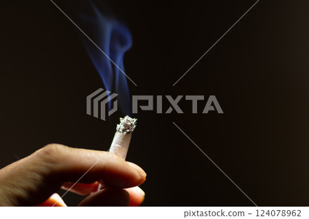 Male hand smoking cigarette Male hand smoking cigarette 124078962
