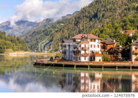 Alleghe, Italy houses and lake in Dolomites Alps 124078976