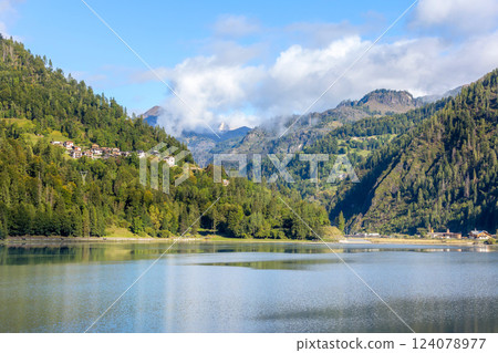 Alleghe, Italy houses and lake in Dolomites Alps 124078977