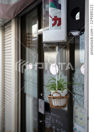 Hanging pot in front of the store 124080121