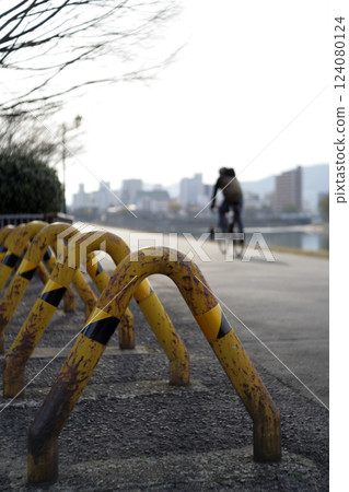 Car stop fence on river bank 124080124