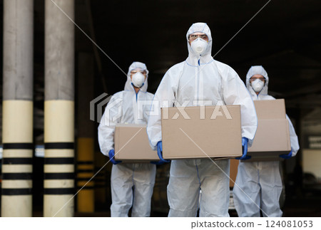 People in protective suits and masks delivering vaccine of coronavirus to population 124081053