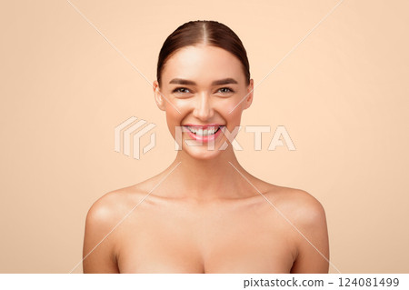 Portrait Of Cheerful Young Lady Smiling Looking At Camera Posing Shirtless In Studio Standing Over Gray Background. Headshot Of Gorgeous Naked Woman Expressing Positive Emotions. Natural Female Beauty 124081499