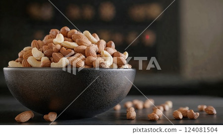 A close-up view of a bowl filled with a variety of nuts, including almonds, cashews, and others. The image showcases the healthy, nutritious, and tasty appeal of this snack choice A close-up view of a bowl filled with a variety of nuts, including almonds, cashews, and others. The image showcases the healthy, nutritious, and tasty appeal of this snack choice 124081504
