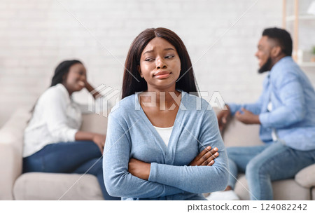 Envy african girl jealous to her dating friends that flirting with each other on background 124082242