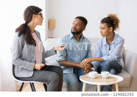 Professional Psychologist Advising African American Spouses Helping Them Restore Marriage In Office. Panorama 124082293