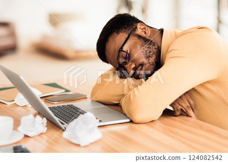 Feeling Exhausted. Tired black businessman sleeping at workplace after hard day. Copy space 124082542