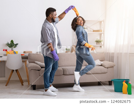 Loving African American Couple Dancing While Cleaning Flat Together, Having Fun At Home, Copy Space 124082675
