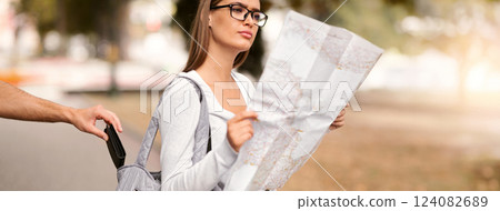 Pickpocket Thief Stealing Wallet From Traveler Woman's Bag While She Looking At Tourist Map Standing Outside. Cropped, Selective Focus 124082689