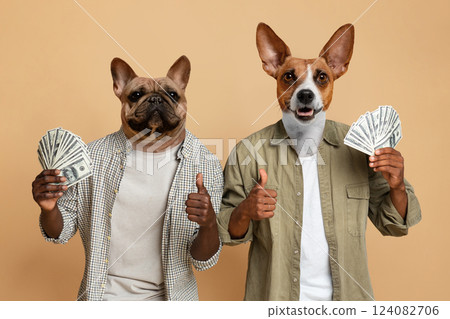 Two dogs, one a French Bulldog and one a Jack Russell, are wearing shirts and holding money in their paws. They are both giving thumbs up and looking directly at the camera. Two dogs, one a French Bulldog and one a Jack Russell, are wearing shirts and holding money in their paws. They are both giving thumbs up and looking directly at the camera. 124082706