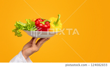 Salad Recipes. Unrecognizable Chef Guy Holding Plate With Vegetables Over White Studio Background. Panorama, Cropped, Copy Space Salad Recipes. Unrecognizable Chef Guy Holding Plate With Vegetables Over White Studio Background. Panorama, Cropped, Copy Space 124082833