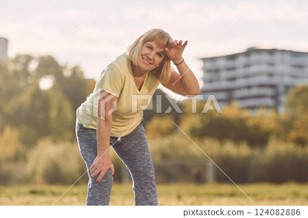 Standing and enjoying summer weather. Senior woman having nice weekend outdoors on the field at sunny day Standing and enjoying summer weather. Senior woman having nice weekend outdoors on the field at sunny day 124082886