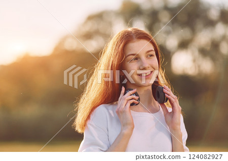 Portrait of young girl that is on the field at sunny daytime having nice weekend 124082927