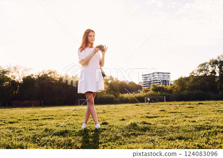 Young girl is on the field at sunny daytime having nice weekend Young girl is on the field at sunny daytime having nice weekend 124083096