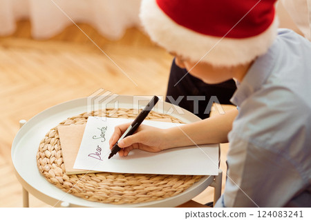 Xmas Gifts Wishlist. Boy Writing Letter To Santa Claus Sitting On Sofa At Home. Selective Focus 124083241
