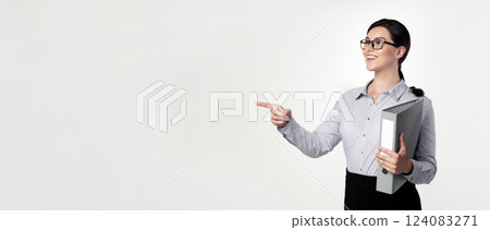 Business And Employment. Smiling Career Girl Pointing Finger Aside Holding Folder With Papers On White Studio Background. Business And Employment. Smiling Career Girl Pointing Finger Aside Holding Folder With Papers On White Studio Background. 124083271