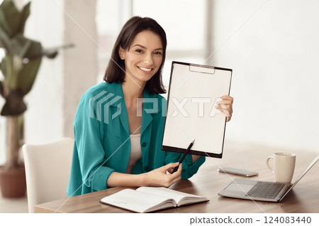 Doing Survey Research. Young woman showing clipboard paperholder working at office, copyspace Doing Survey Research. Young woman showing clipboard paperholder working at office, copyspace 124083440