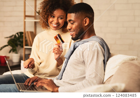 Happy spouses shopping online on laptop, ordering new clothes at home 124083485