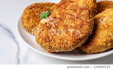 macro photo of Kiev-style cutlet in a plate on a white marble servery table 124084325