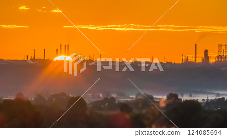 Scarlet sunrise over a chemical plant with pipes Scarlet sunrise over a chemical plant with pipes 124085694